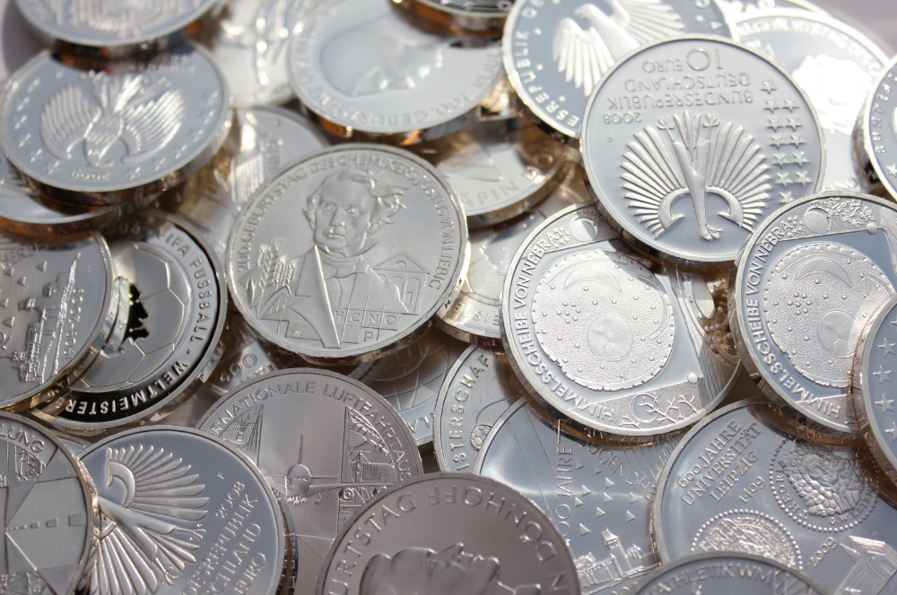 Modern silver commemorative coins with detailed engravings – expert Coin Buyers in Lubbock evaluating collections.